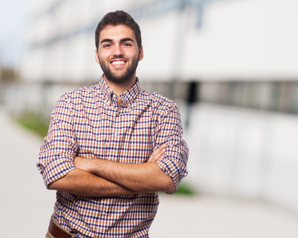 portrait of a handsome young man with crossed arms portrait of a handsome young man with crossed arms