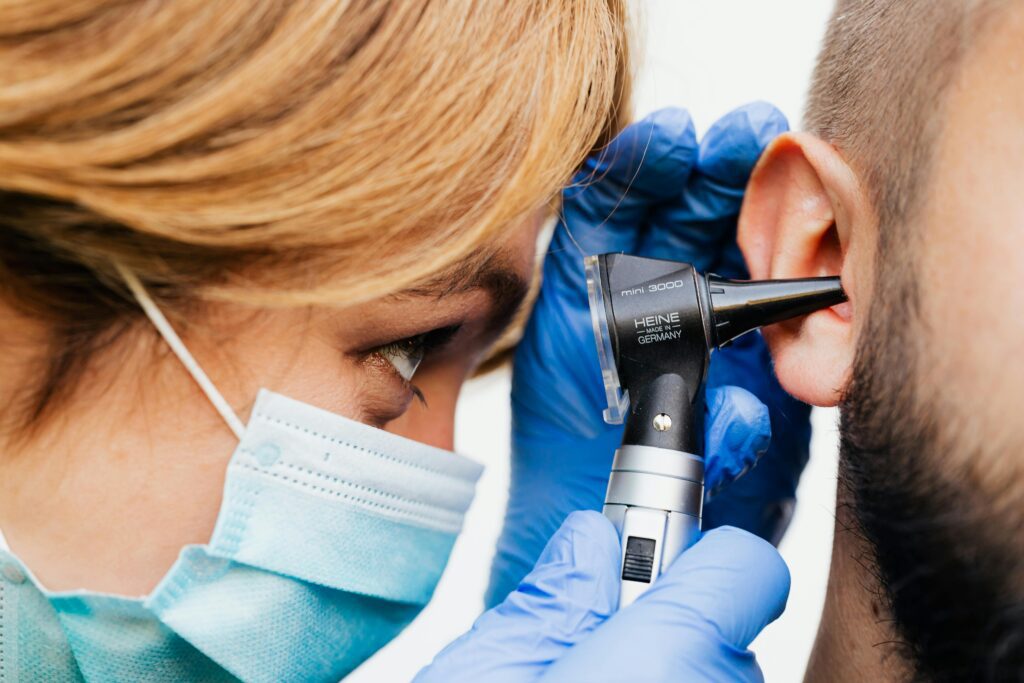 pexels photo 5206942 5206942 Close-up of a doctor performing an ear examination with an otoscope.